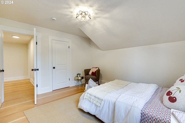 bedroom with hardwood / wood-style flooring and a textured ceiling