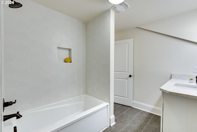 bathroom with tiled shower / bath, vanity, and tile patterned floors