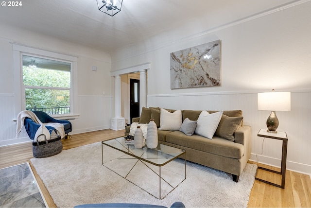 living room featuring decorative columns and wood-type flooring