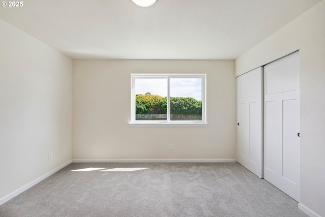 655 11th St SW, Bandon, OR 97411 - unfurnished bedroom with carpet, baseboards, and a closet