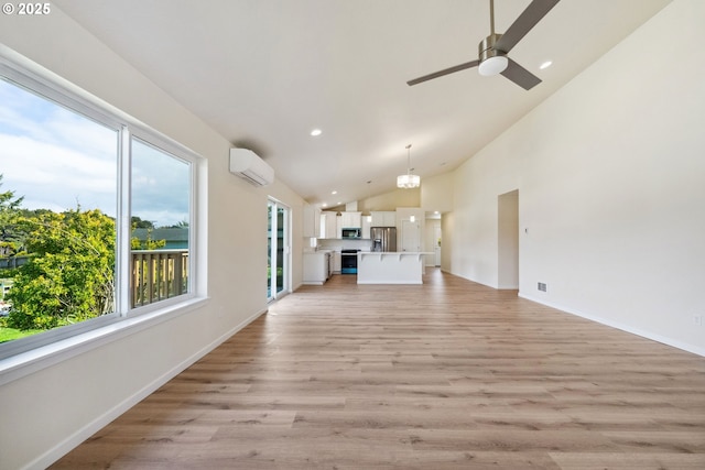 655 11th St SW, Bandon, OR 97411 - unfurnished living room with an AC wall unit, healthy amount of natural light, light wood-style floors, a ceiling fan, and recessed lighting