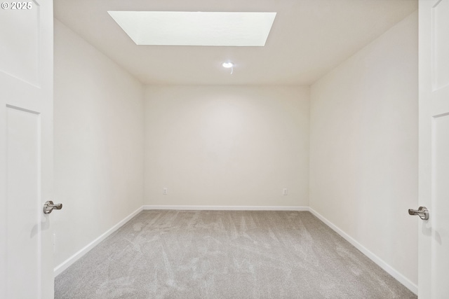 655 11th St SW, Bandon, OR 97411 - unfurnished room with light colored carpet, a skylight, and baseboards