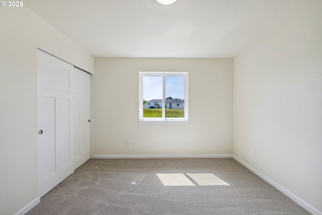 655 11th St SW, Bandon, OR 97411 - unfurnished bedroom featuring carpet flooring, baseboards, and a closet