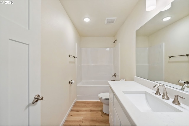 655 11th St SW, Bandon, OR 97411 - full bath with toilet, vanity, wood finished floors, shower / tub combination, and baseboards