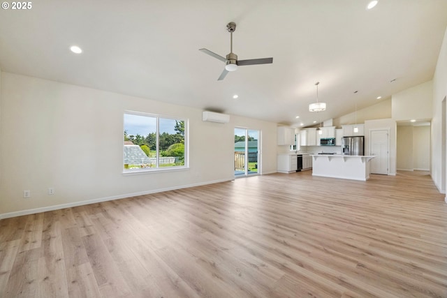 655 11th St SW, Bandon, OR 97411 - unfurnished living room with a wall mounted air conditioner, light wood finished floors, ceiling fan, recessed lighting, and baseboards