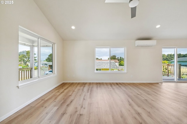 655 11th St SW, Bandon, OR 97411 - spare room featuring an AC wall unit, light wood-style flooring, vaulted ceiling, baseboards, and a ceiling fan
