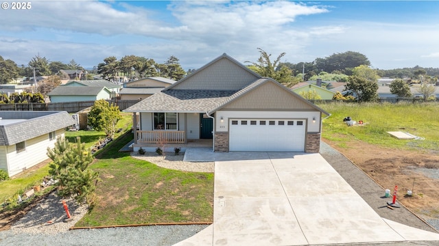 655 11th St SW, Bandon, OR 97411 - view of front of house with a porch, an attached garage, concrete driveway, roof with shingles, and a front yard