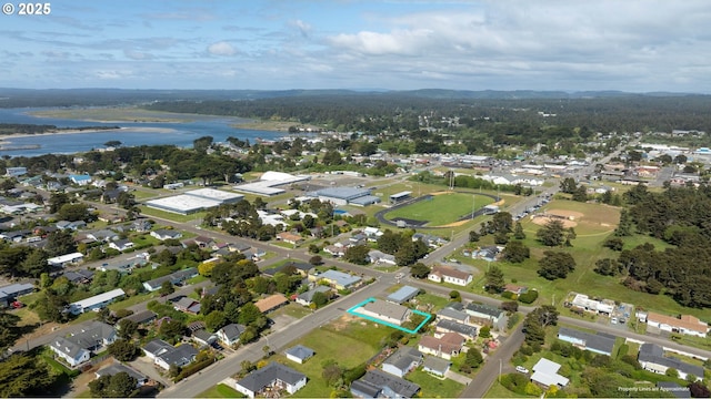655 11th St SW, Bandon, OR 97411 - aerial overview of property's location with a large body of water, property boundaries highlighted, and nearby suburban area