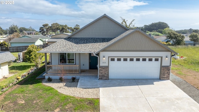 655 11th St SW, Bandon, OR 97411 - view of front of home with covered porch, a shingled roof, driveway, an attached garage, and a front yard