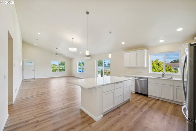 655 11th St SW, Bandon, OR 97411 - kitchen with stainless steel appliances, a sink, light wood finished floors, recessed lighting, and white cabinetry