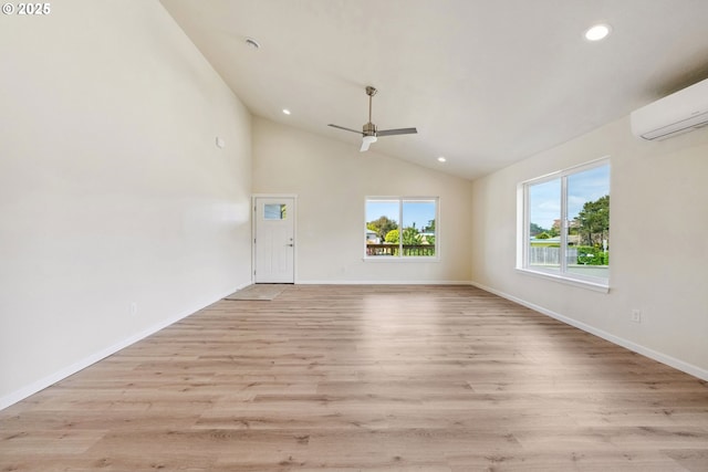 655 11th St SW, Bandon, OR 97411 - unfurnished room with a ceiling fan, recessed lighting, vaulted ceiling, light wood-style floors, and a wall unit AC