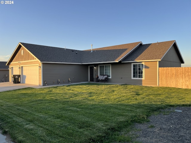 ranch-style home featuring a garage and a front lawn