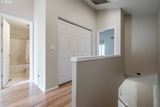 hallway with light hardwood / wood-style floors