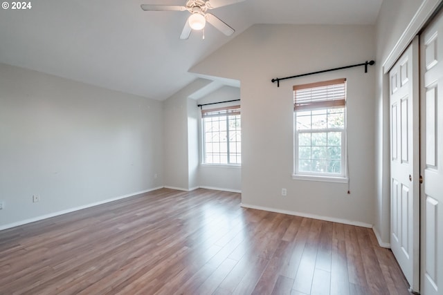 unfurnished room featuring light hardwood / wood-style floors, vaulted ceiling, and ceiling fan