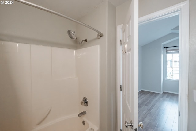 bathroom featuring wood-type flooring and washtub / shower combination