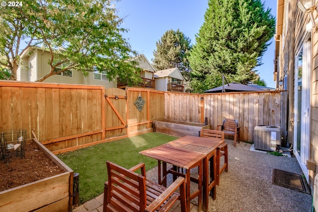 view of yard featuring a patio and central AC unit