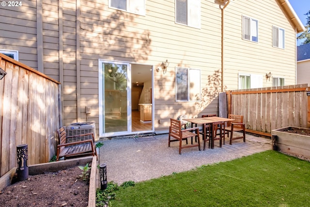 rear view of house with a yard and a patio