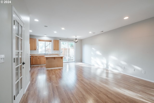 interior space with light hardwood / wood-style flooring and an inviting chandelier