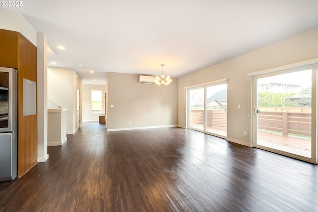 interior space featuring a wall mounted AC, dark hardwood / wood-style flooring, and an inviting chandelier