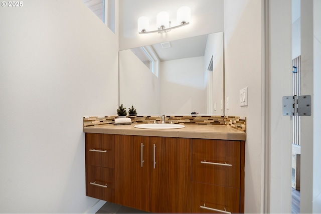 bathroom with vanity, tile patterned floors, and backsplash