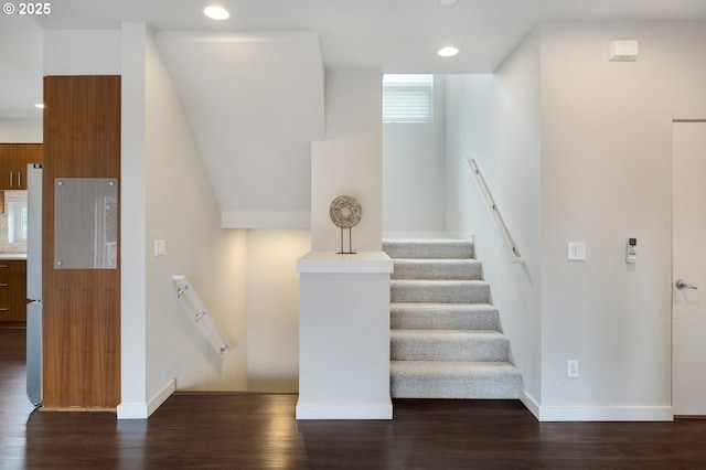 staircase with hardwood / wood-style floors