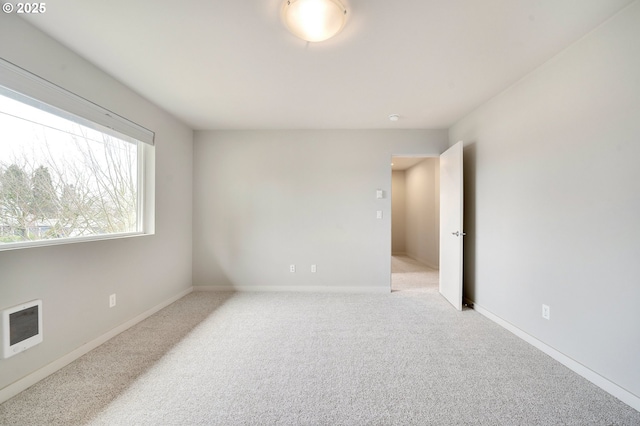 carpeted empty room with heating unit