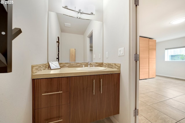 bathroom featuring vanity, tile patterned floors, and decorative backsplash