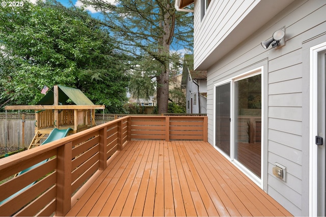 wooden terrace with a playground