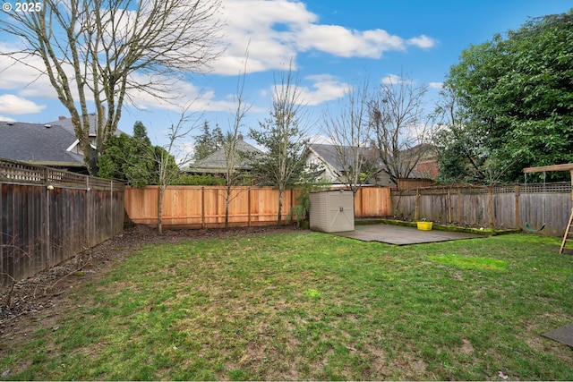 view of yard with a patio and a storage shed