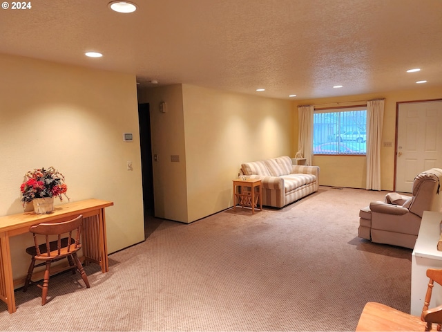 living room featuring light carpet and a textured ceiling