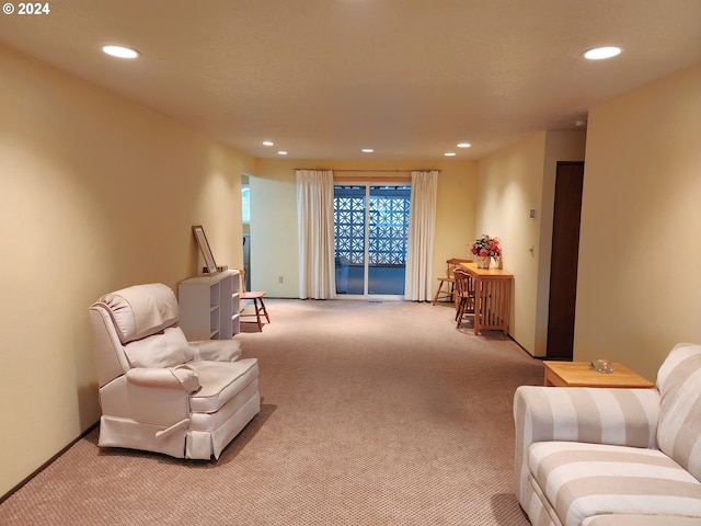 sitting room featuring light colored carpet