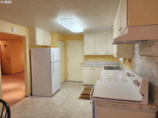 kitchen with range, white cabinetry, sink, white refrigerator, and light colored carpet