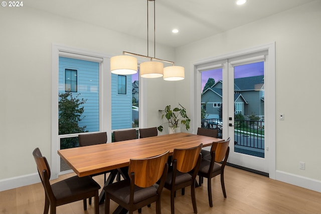 dining area featuring light wood-type flooring and french doors