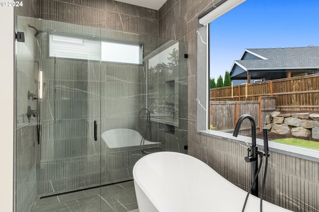 bathroom featuring separate shower and tub