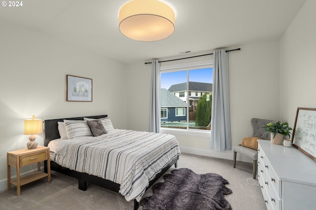 bedroom featuring light carpet