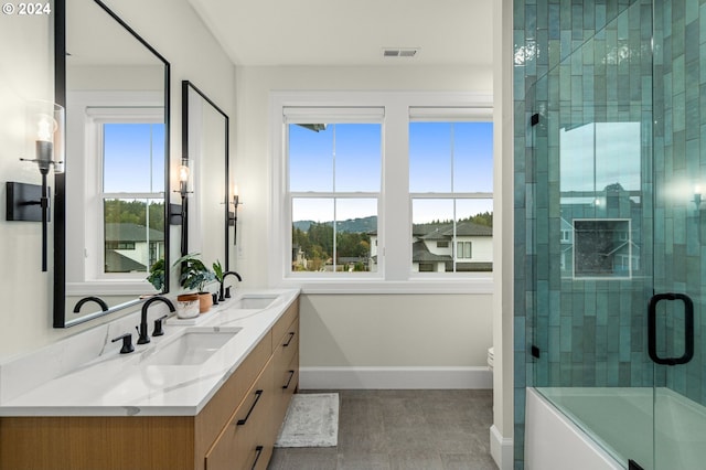 bathroom featuring a shower with door, vanity, and toilet