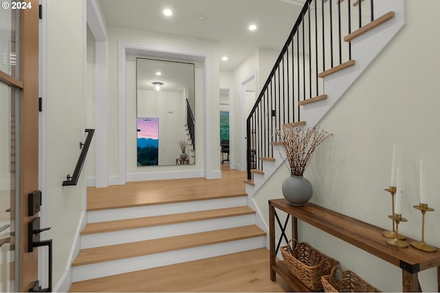 stairway with hardwood / wood-style floors