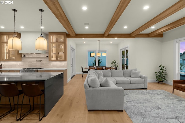 living room featuring light wood-type flooring and beam ceiling