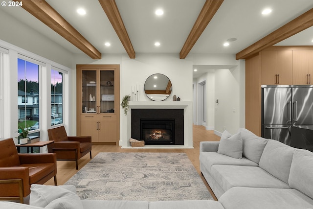 living room featuring beam ceiling and light wood-type flooring