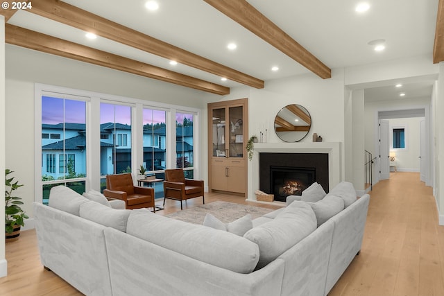 living room with beam ceiling and light hardwood / wood-style floors