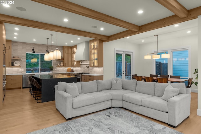 living room featuring light hardwood / wood-style floors and beam ceiling