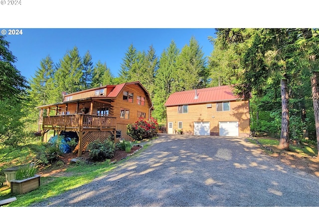 view of front of home featuring a garage and a wooden deck