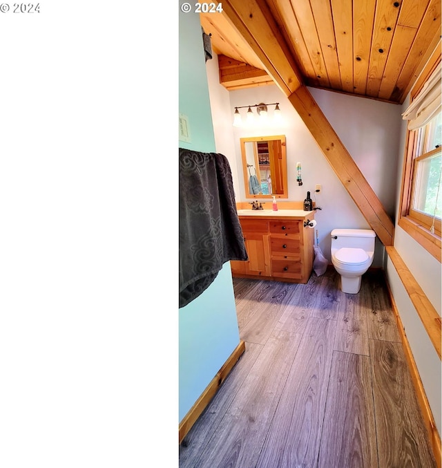 bathroom with hardwood / wood-style flooring, beam ceiling, vanity, wood ceiling, and toilet