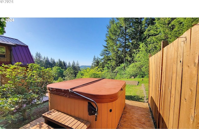 wooden terrace with a hot tub