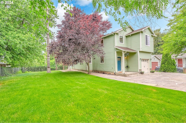 view of front facade with a front yard and a garage