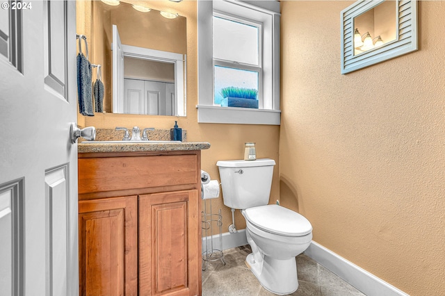 unfurnished bedroom with a spacious closet, a closet, ensuite bath, light colored carpet, and a textured ceiling