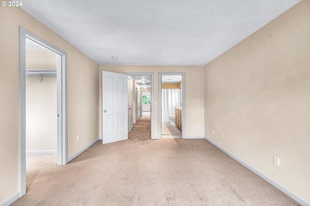 carpeted spare room with a textured ceiling