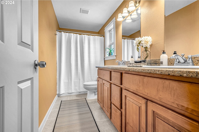 bathroom with tile patterned flooring, vanity, and toilet