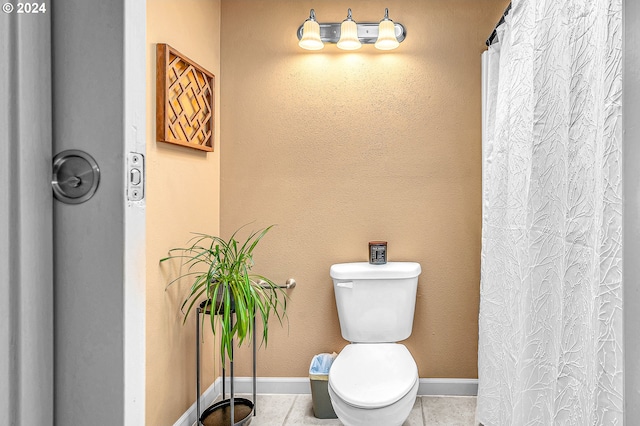 bathroom with a shower with shower curtain, toilet, and tile patterned floors