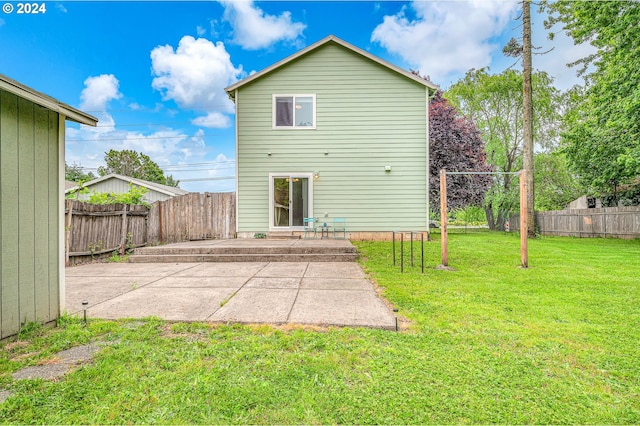 rear view of house featuring a yard and a patio